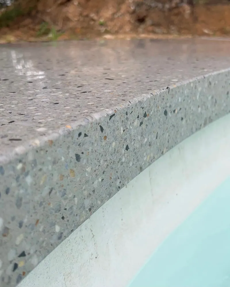 Close view of the Geostone Whitsunday honed finish on the curved pool edge at Bargo