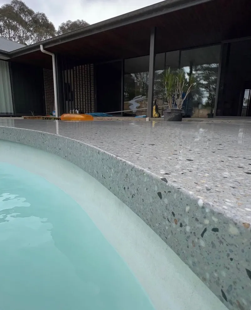Close view of the honed pool surround edge at Bargo, curving around the pool