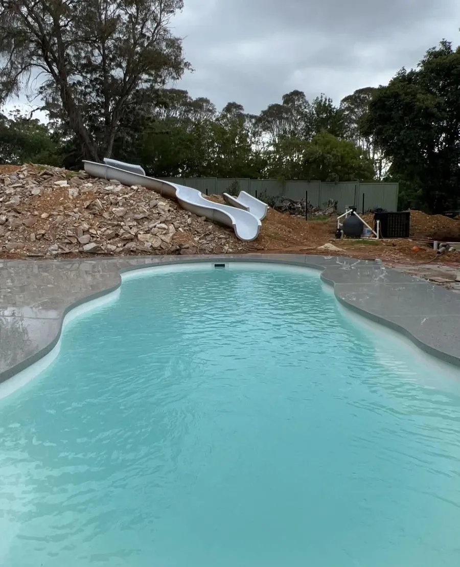 View along the curved Geostone honed pool surround and freeform pool at Bargo, NSW