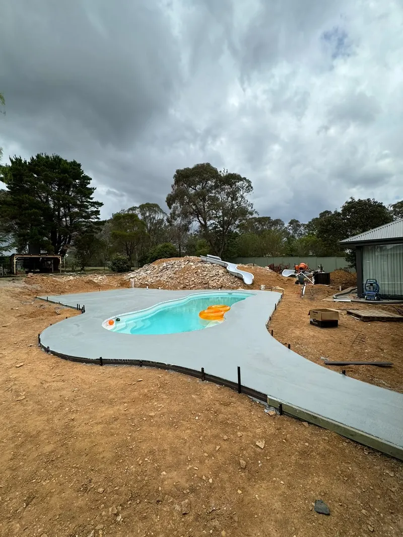 Curved Geostone honed pool surround following the shape of a freeform pool in Bargo, NSW