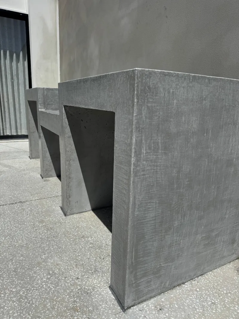 The concrete bench and benchtop against the rendered courtyard wall at Burraneer