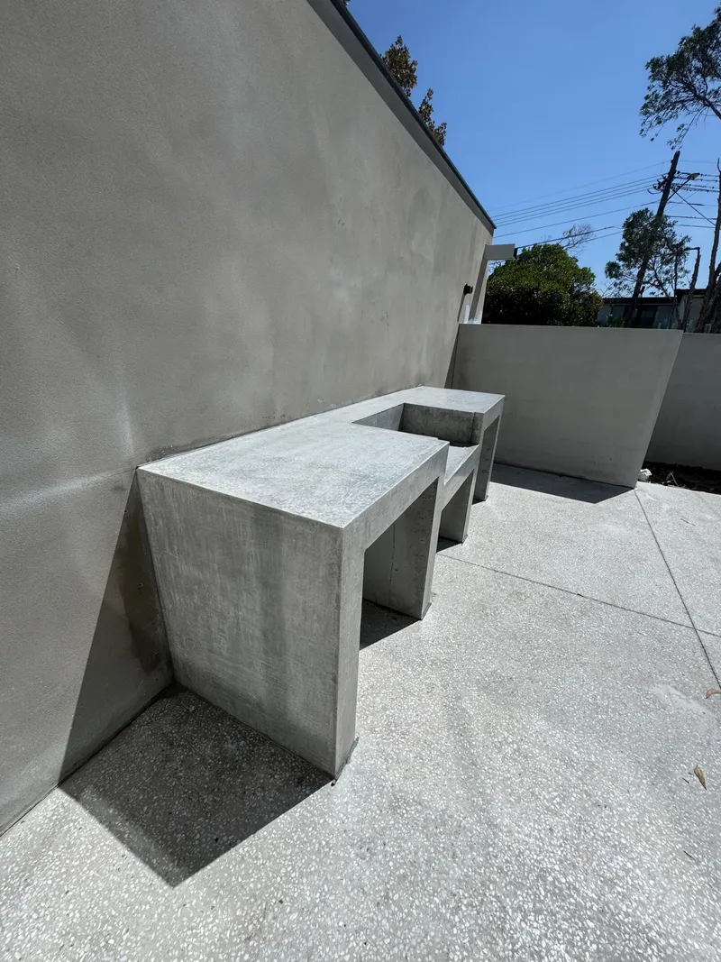 The L-shaped concrete bench and seat built into the courtyard wall at Burraneer