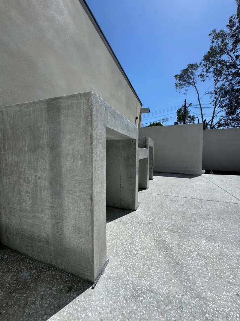 Wide view of the concrete bench, seat and benchtop along the courtyard wall at Burraneer