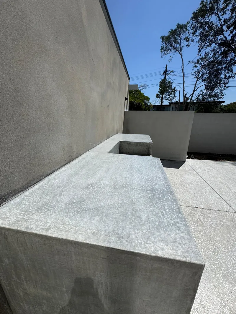 The concrete bench and seat at Burraneer seen from the terrazzo-look courtyard floor