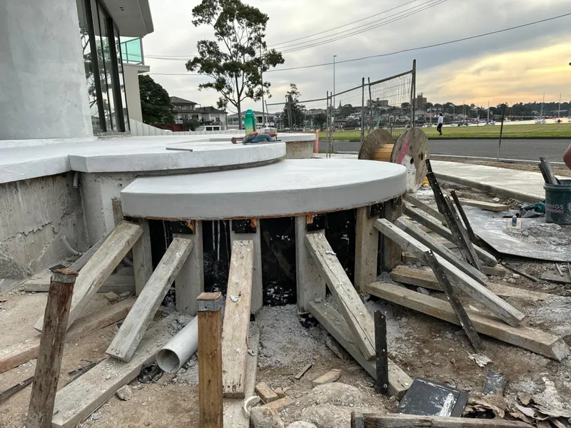 The rounded floating steps at Drummoyne mid-build, formwork still in with the harbour visible behind
