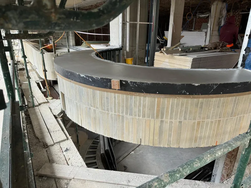A freshly formed curved window sill with materials staged on site at Elizabeth Bay, before the surface was polished