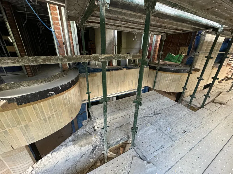 A row of curved window sills receding along the building's facade