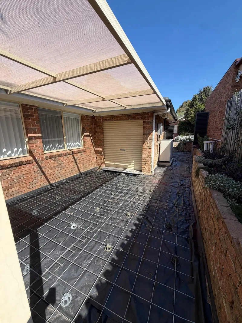 Reinforcement laid along the side path in the backyard at Holsworthy