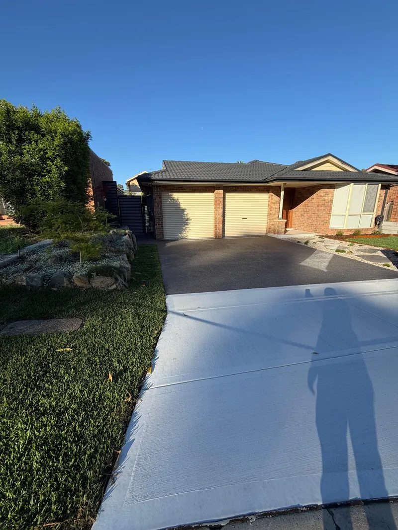 The finished driveway and front yard at Holsworthy in afternoon light