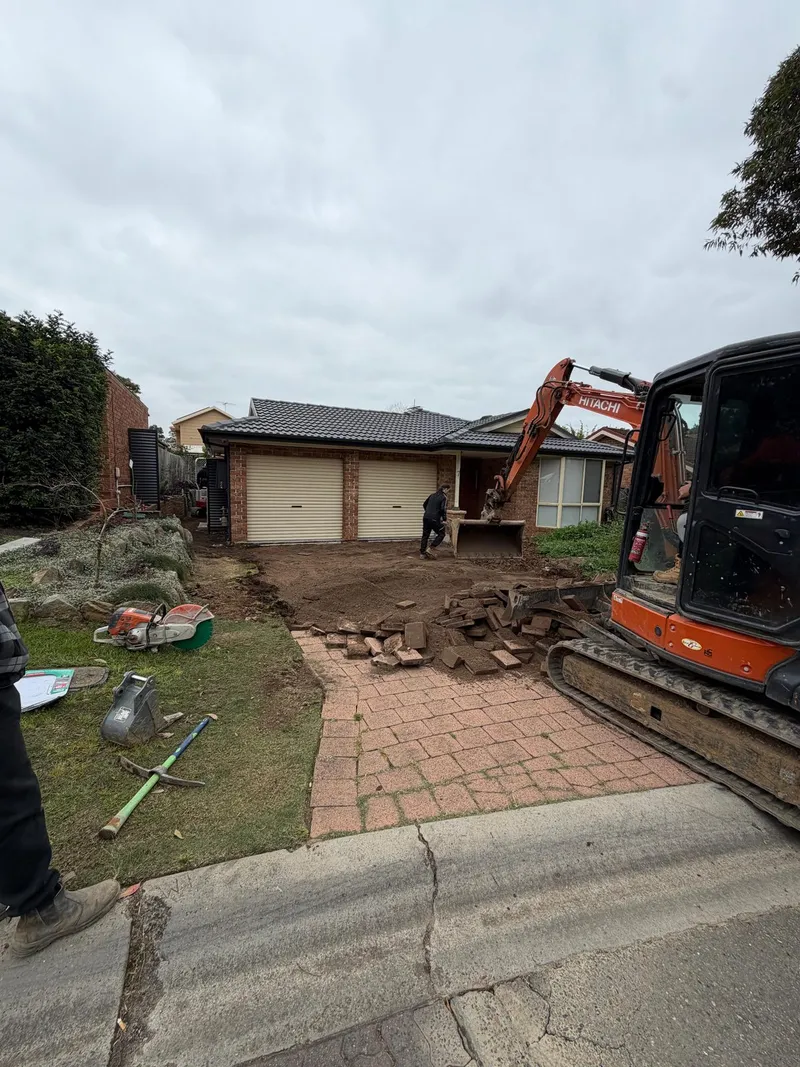 Excavating the old paver driveway and front yard at Holsworthy before the new concrete went in