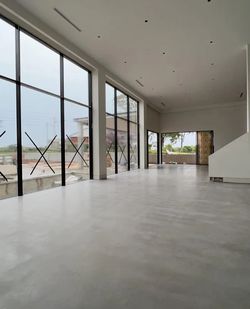 Long view across the burnished concrete floor through the open-plan living area, Horsley Park