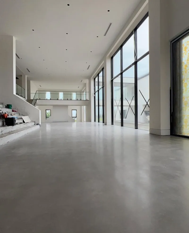 Burnished concrete floor running past the staircase and upstairs void, Horsley Park