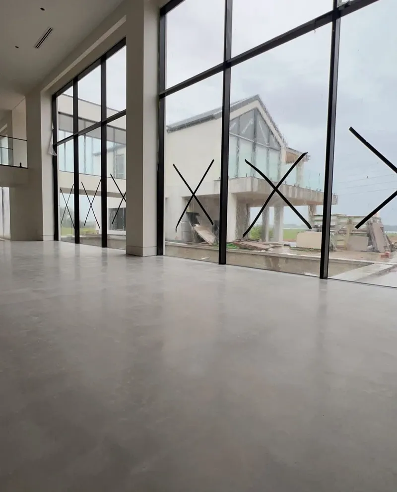 Burnished concrete floor beside floor-to-ceiling glass, Horsley Park