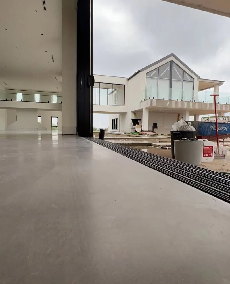 Close view of the burnished concrete floor finish and the sliding door track, Horsley Park