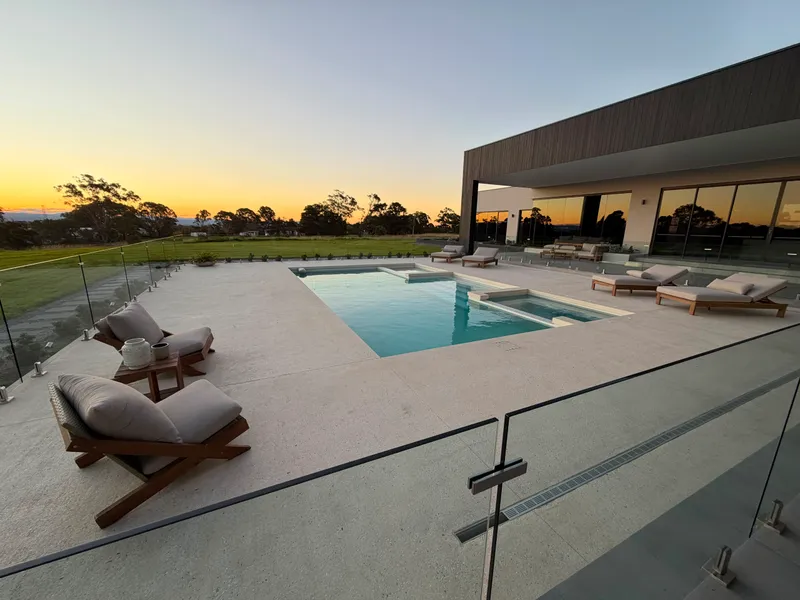 The lounging area of the Horsley Park pool surround, with the exposed aggregate running out to the fence line