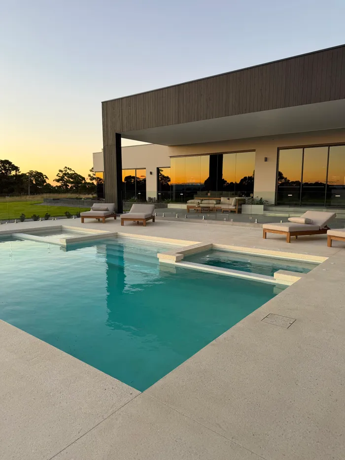 Geostone exposed aggregate pool and spa surround at sunset in Horsley Park NSW