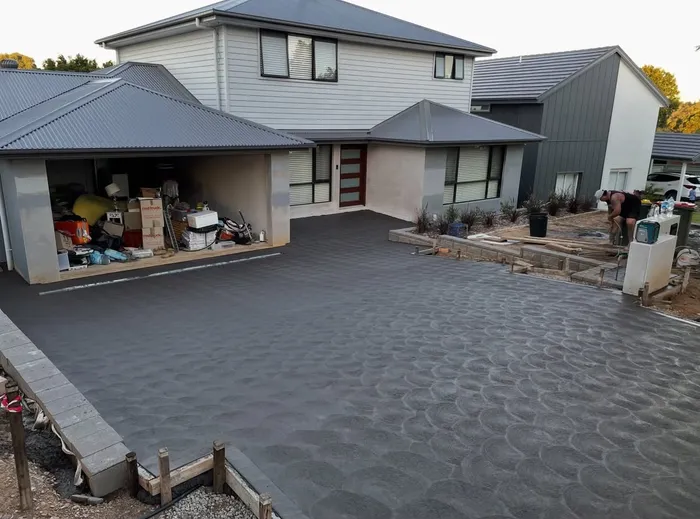 Finished charcoal concrete driveway with a coved finish at a home in Lalor Park, NSW