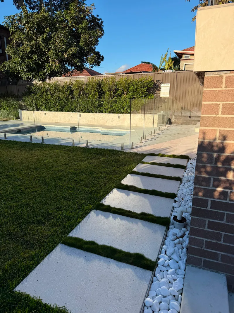 The stepping stones at Matraville leading across the lawn to the glass-fenced pool