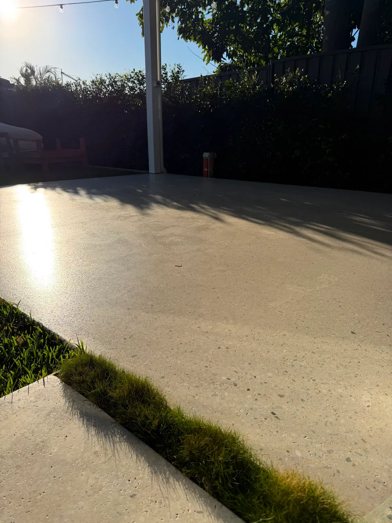 Low view across the Matraville cabana slab with the sun catching the honed surface