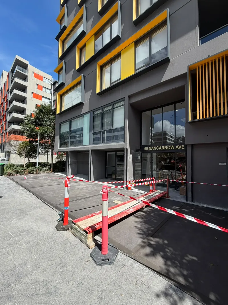 The freshly poured concrete at the main 60 Nancarrow Ave entrance, taped off to cure