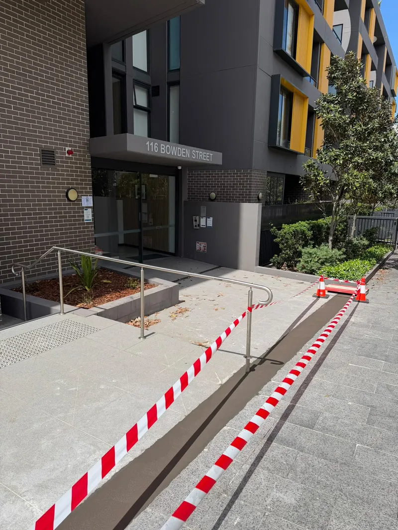 Barrier tape along the path from the street to the 116 Bowden Street entrance before work began there