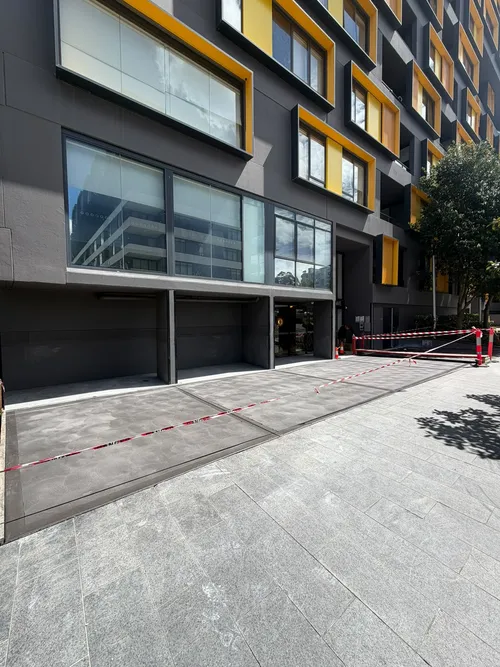 The finished charcoal concrete entrance at 60 Nancarrow Ave, Meadowbank, taped off to cure