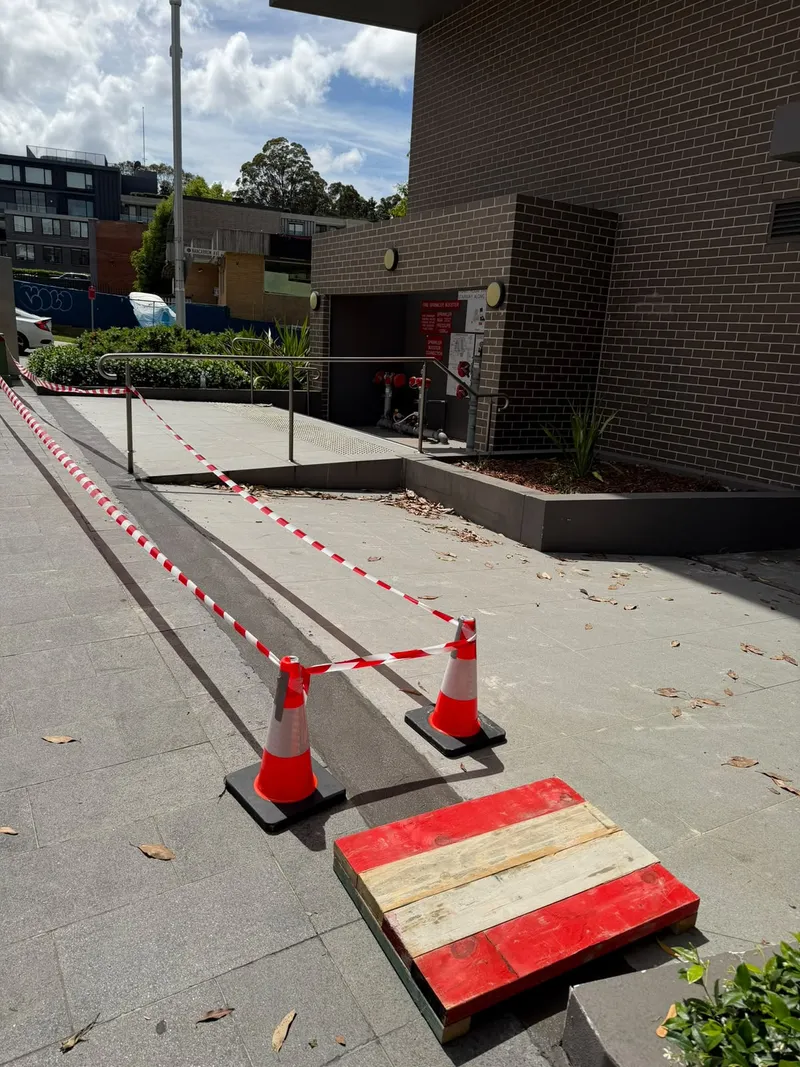 Cones and tape set out at the fire sprinkler booster side path off Nancarrow Ave before work started