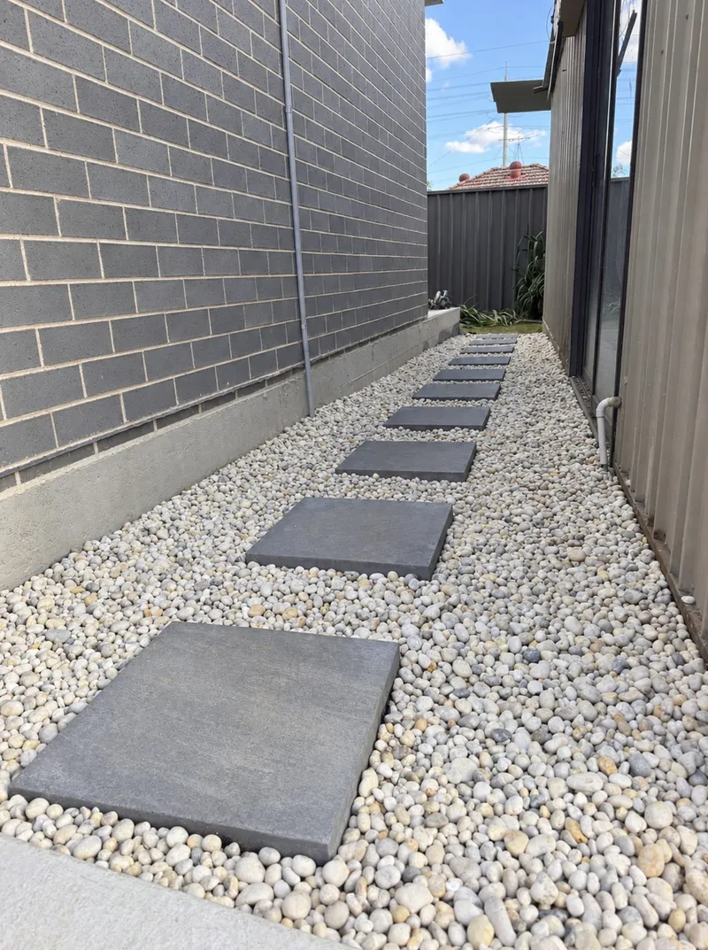 Paver stepping stones set in pebbles along the side path at Old Toongabbie