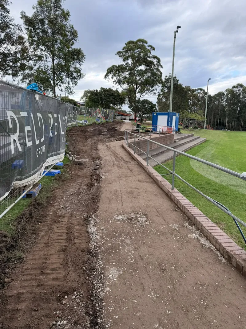 Steel reinforcement laid in formwork along the brick edging and guard rail before the pour